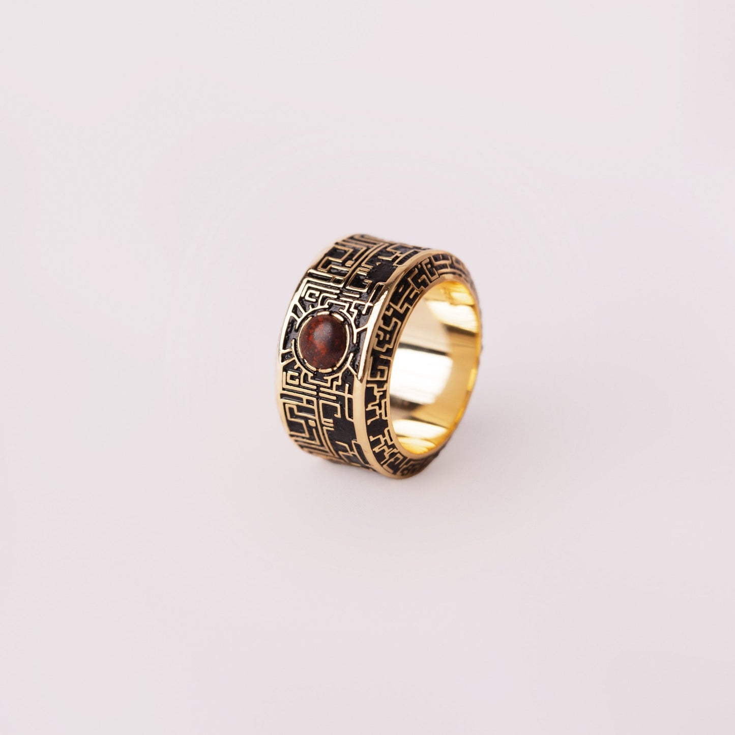 labyrinth ring with gemstone on a white background