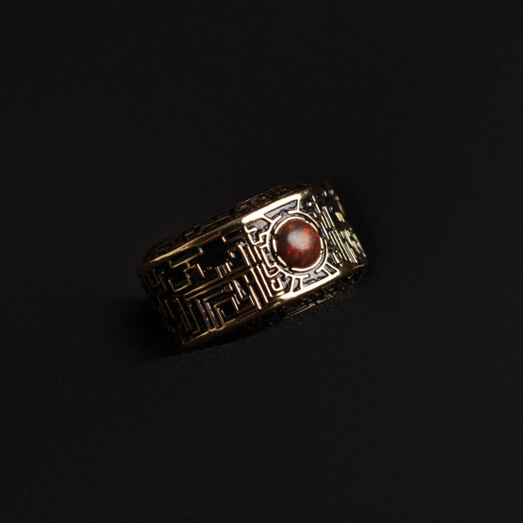 circuit ring with red stone on a dark background