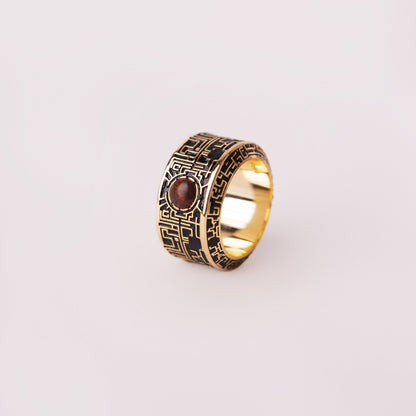labyrinth ring with gemstone on a white background