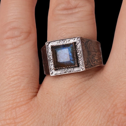 blue stone ring on finger